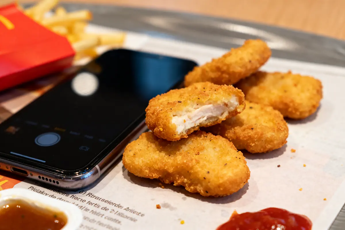 Nuggets de McDo, accompagnés de frites et téléphone sur table en restaurant